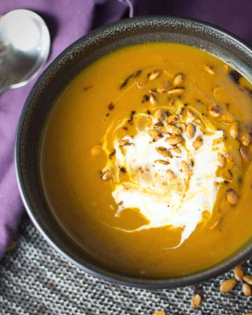 spicy pumpkin soup served with toasted pepitas and creme fraiche