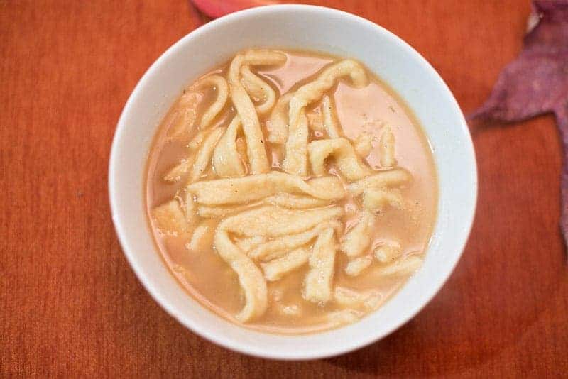 Homemade drop noodles in rich turkey broth.