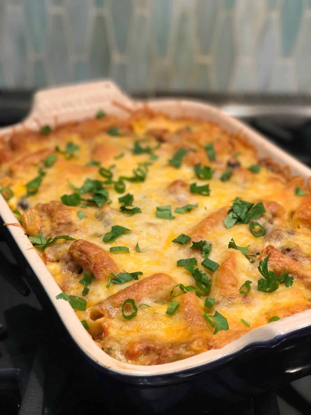 Enchilada Pasta casserole in a le creuset casserole dish. recipe by foodology geek