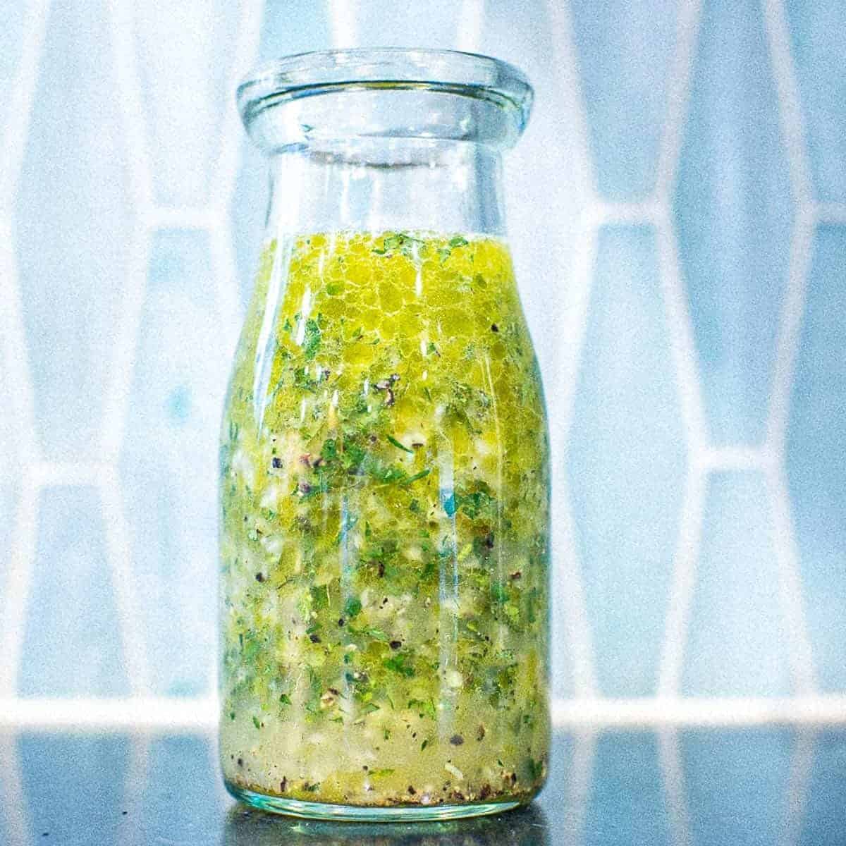 Homemade greek salad dressing with olive oil.