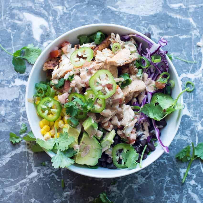 Southwest chicken meal prep bowl.Chipotle chicken with corn, beans, and vegetables. by foodology geek