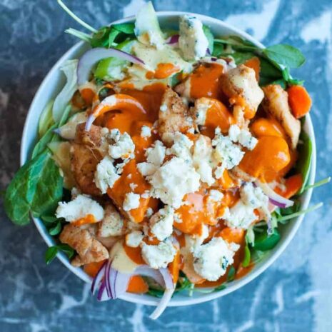 Buffalo Chicken Beast Bowl square Hot wing meal prep recipe. All the flavor of hot wings in a healthy easy to make protein bowl. by foodology geek.