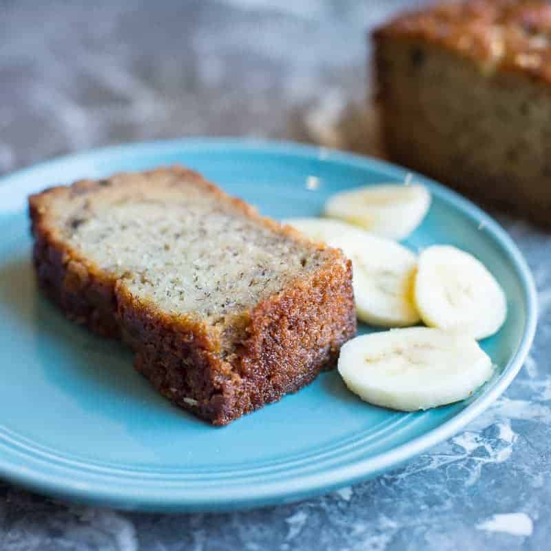 Slice of Papa's Banana Bread with a few sliced bananas. by foodology geek.