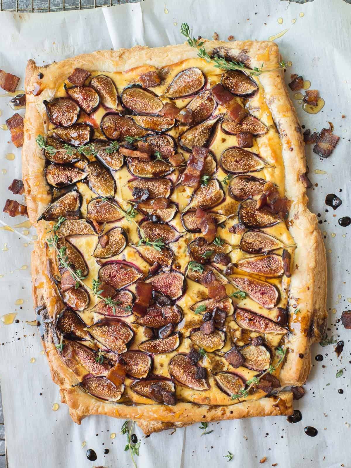fig tart with crispy bacon and a balsamic glaze drizzled on top