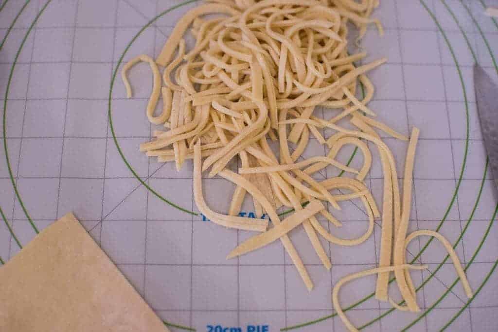 Hand cut dumpling noodles ready to drop into boiling broth.