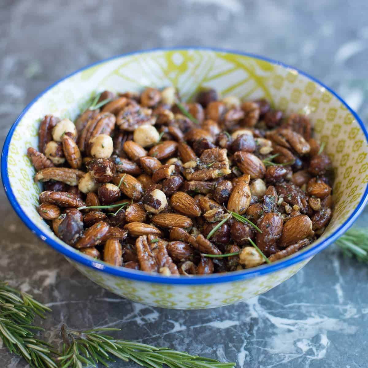 bowl of savory spiced nuts by foodology geek