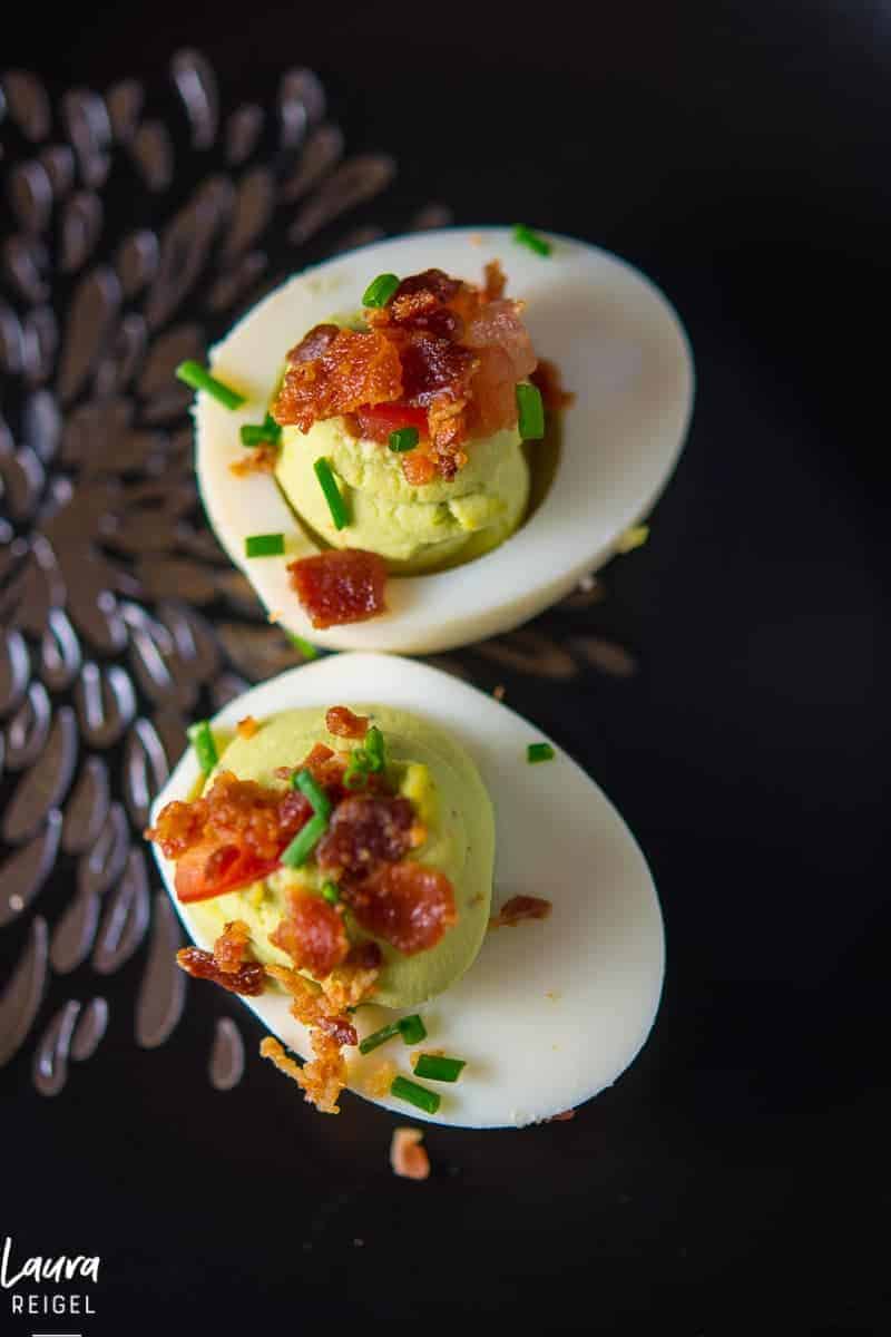 Deviled Avocado Easter eggs with crispy bacon. Is your mouth watering right now? 