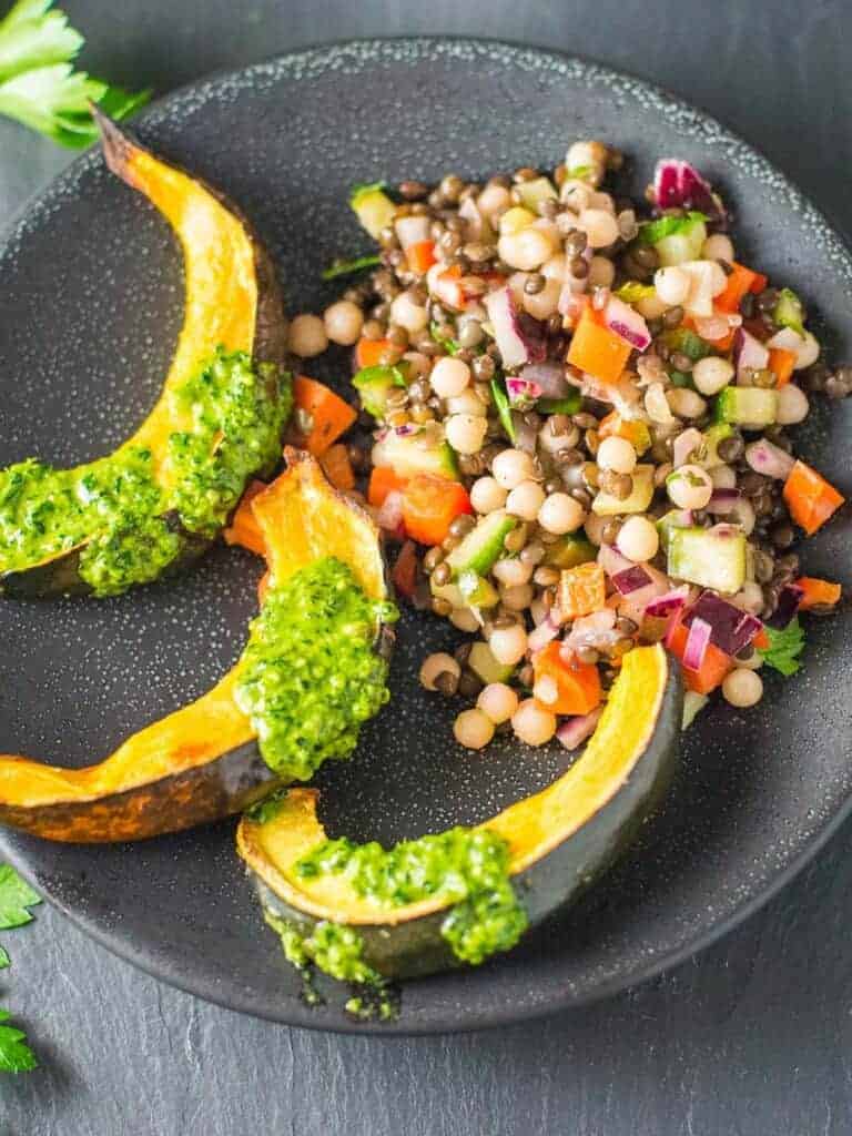 cous cous salad served with roasted acorn squash and kale pesto