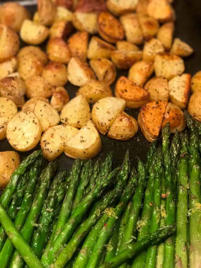 roasted sweet potatoes and asparagus on a baking sheet.