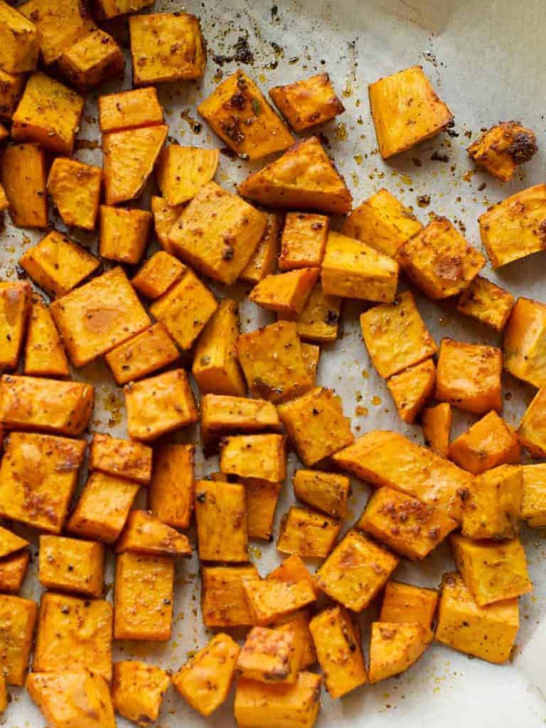 oven roasted sweet potatoes on a baking sheet, seasoned with bbq spice rub