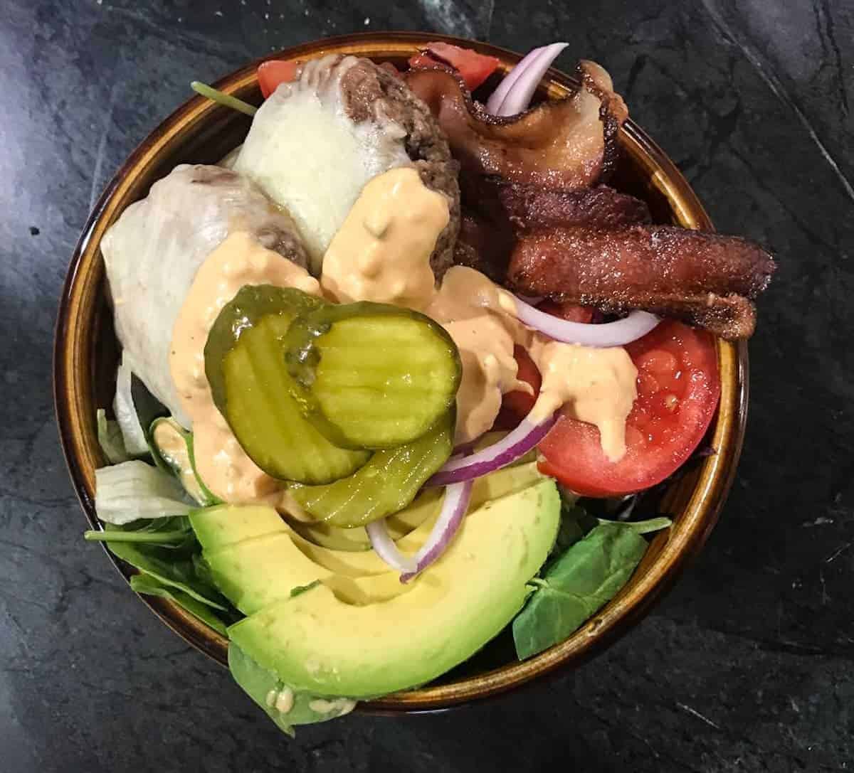 Healthy Cheeseburger Meal Prep Bowl with fresh veggies, bacon, special sauce, and mini cheeseburgers. 