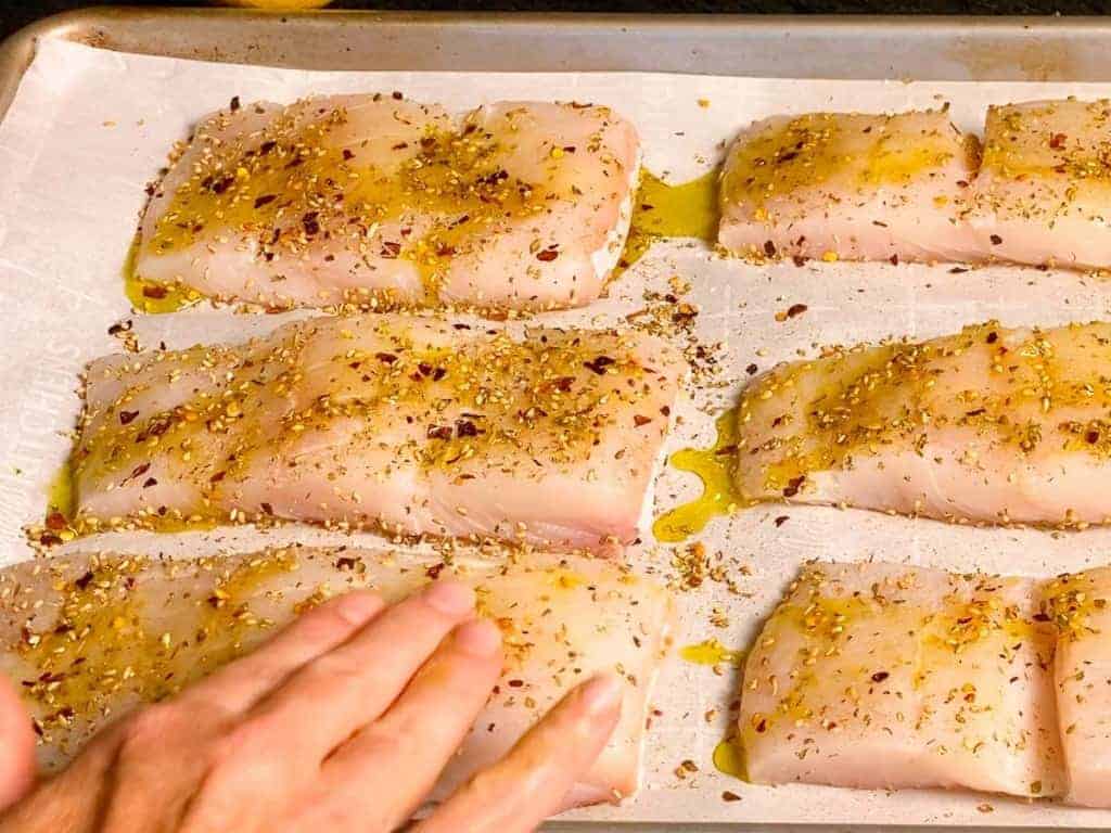 Drizzle each piece of halibut with olive oil, rub in with your fingers