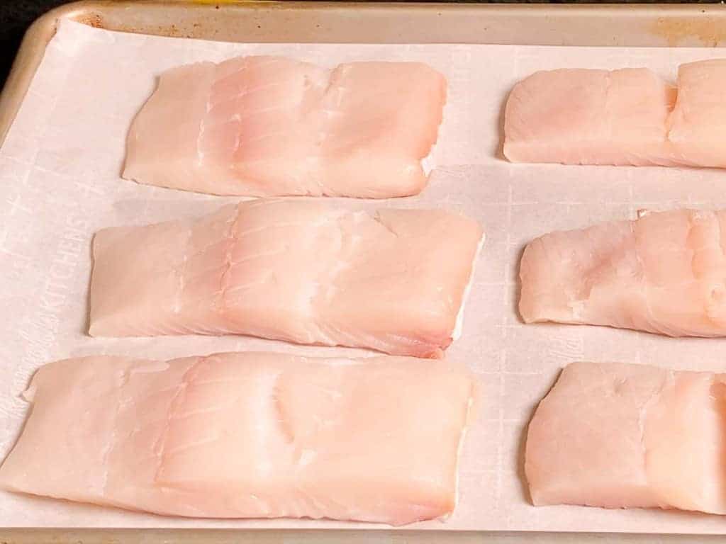 halibut on a parchment lined baking sheet