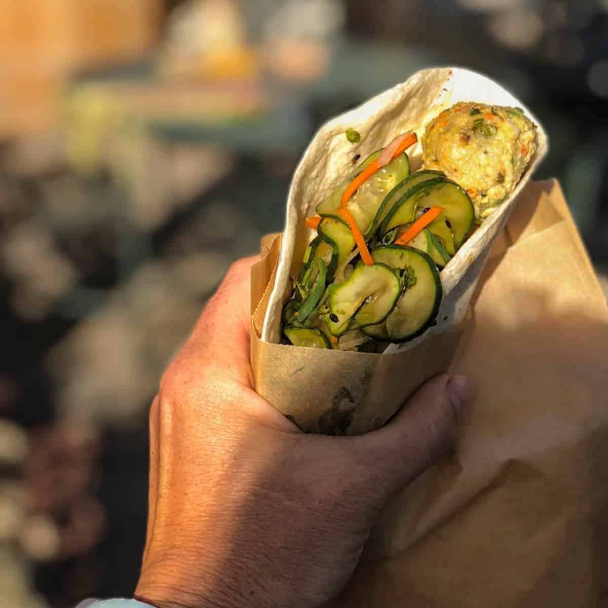 asian chicken meatballs in a tortilla with crunchy vegetables.