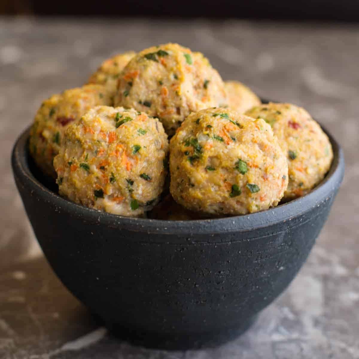 A bowl to thai chicken meatballs.