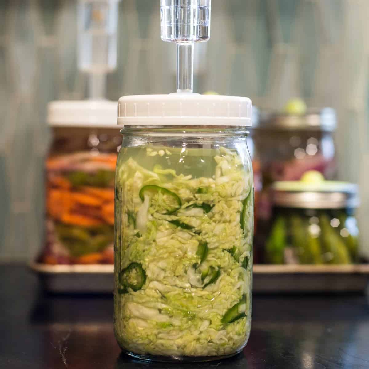 Spicy jalapeño sauerkraut recipe pictures with spicy fermented carrots and pickled onions