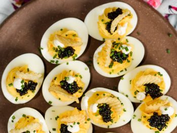 Unpretentiously fancy deviled eggs with caviar and potato chips.
