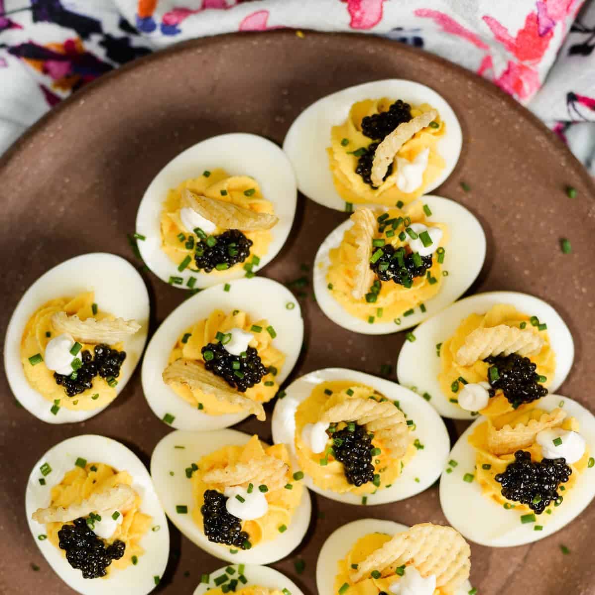 Unpretentious deviled eggs with caviar and chips.