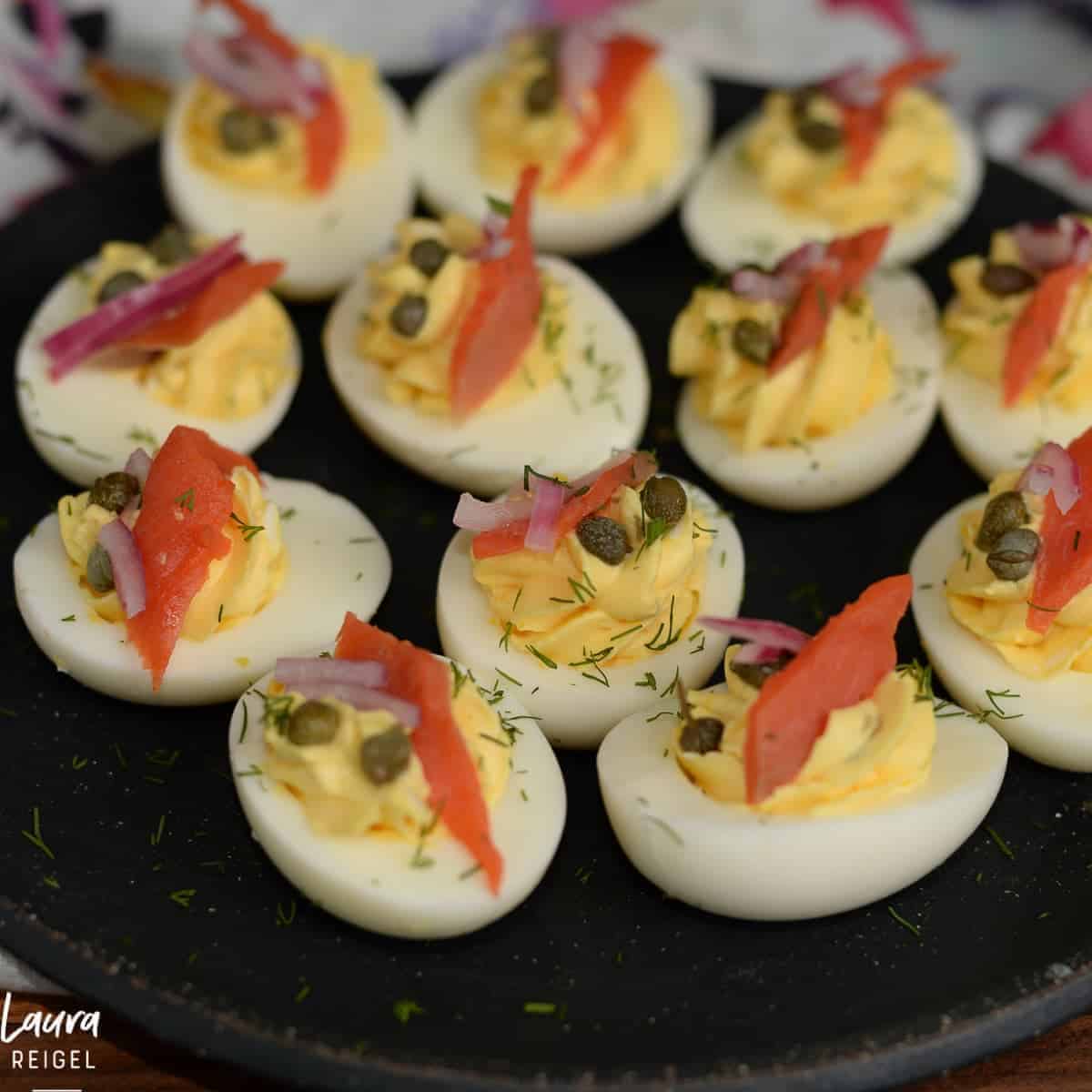 Deviled eggs with smoked salmon, capers and pickled red onions