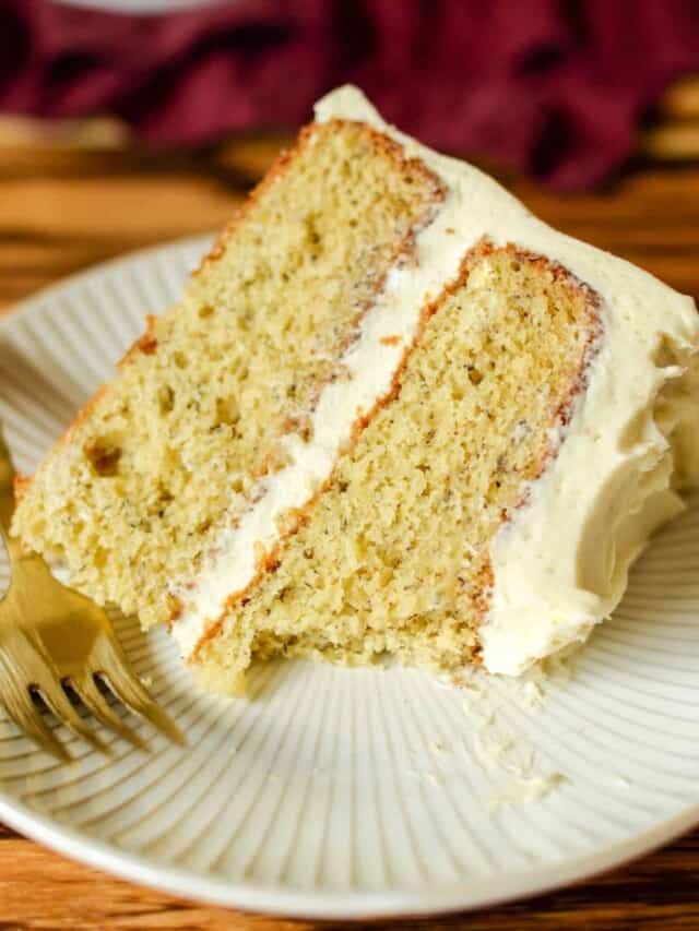 a slice of light and fluffy banana cake with cream cheese frosting