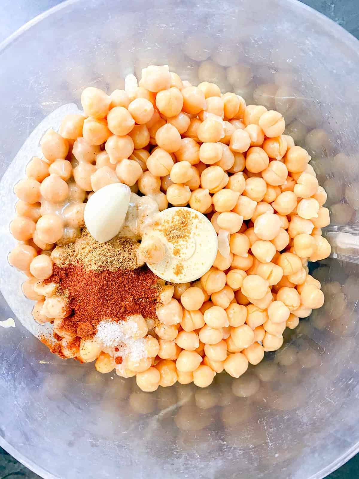 add the spices and the chickpeas to a food processor