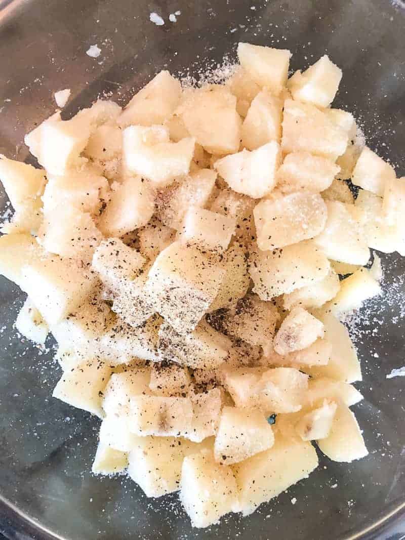 making potato salad. add the vinegar to warm potatoes and add salt and pepper
