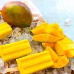 Fresh mango frozen popsicles with fresh cut mango