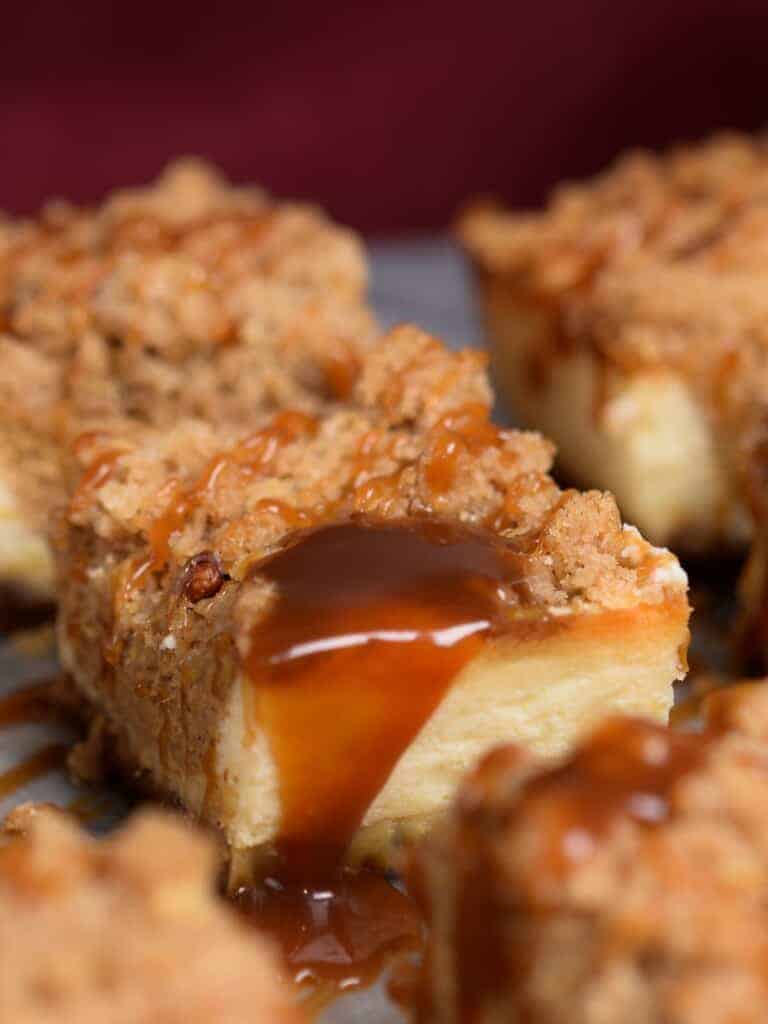 pumpkin cheesecake bars with cinnamon streusel and caramel sauce