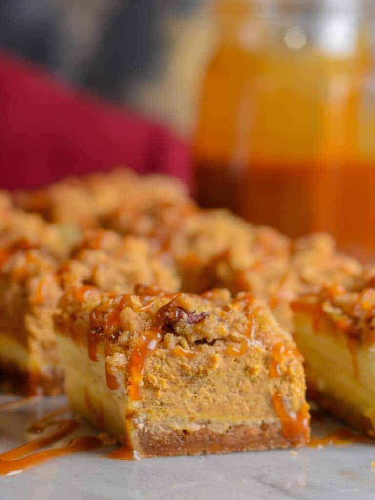pumpkin cheesecake bars with cinnamon streusel and caramel sauce