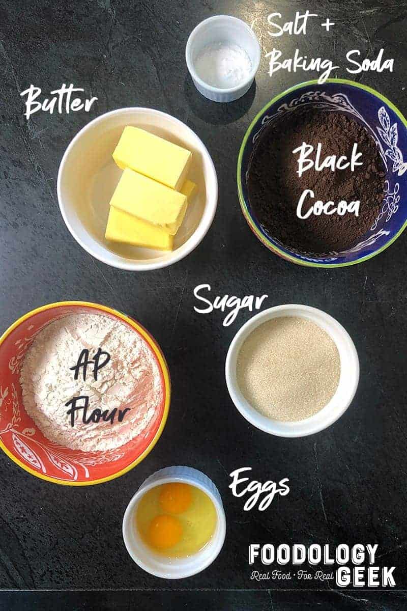 Ingredients for chocolate sandwich cookie dough. Butter, sugar, flour, salt, baking soda, cocoa.