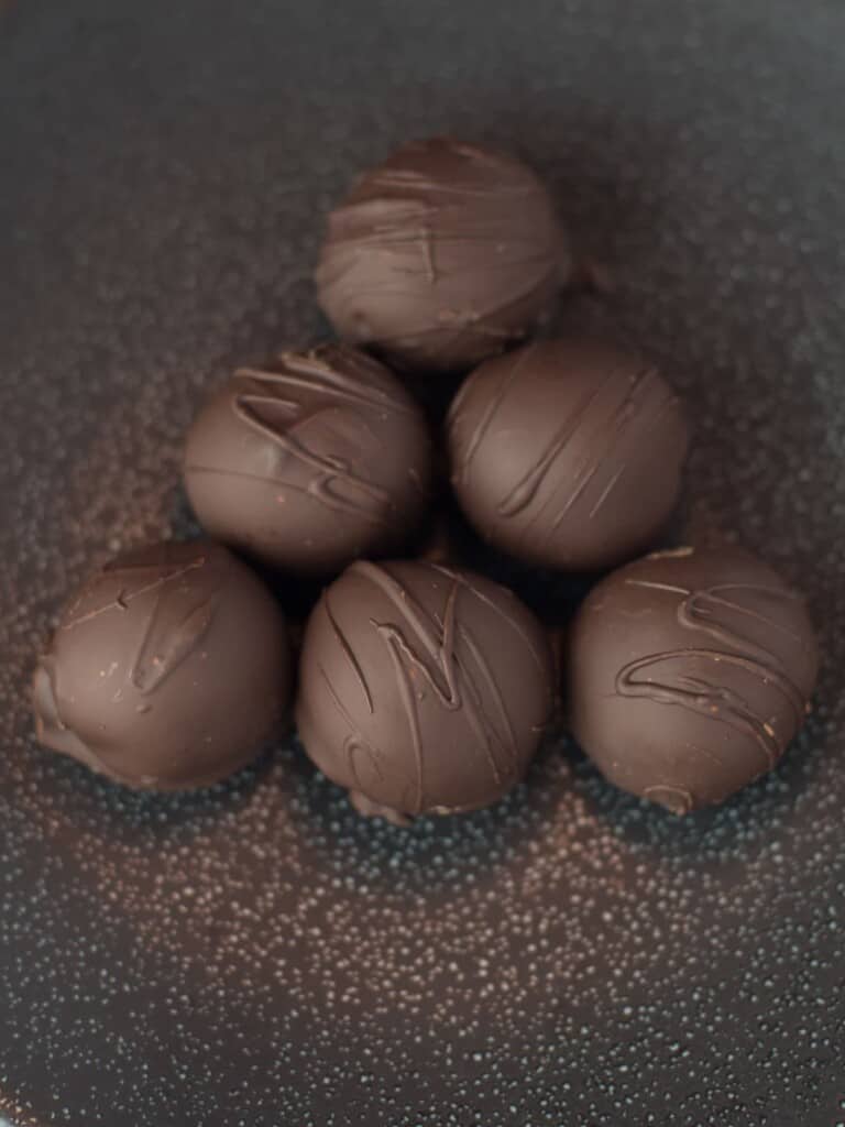 decorated homemade chocolate truffles on a plate