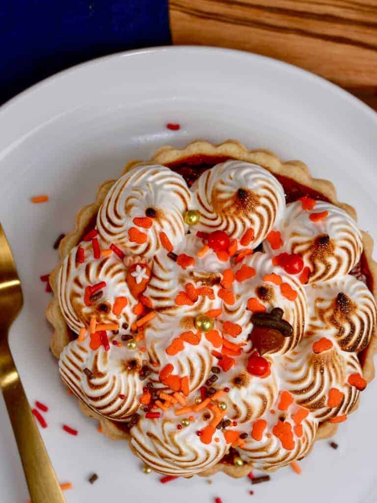 mini pumpkin pies topped with italian meringue and thanksgiving sprinkles