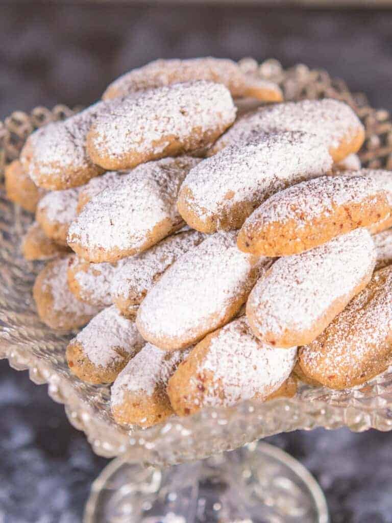 Pecan Christmas cookies lightly dusted with powdered sugar