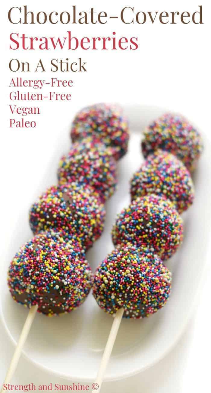 Chocolate covered strawberries on a stick. decorated with sprinkles.