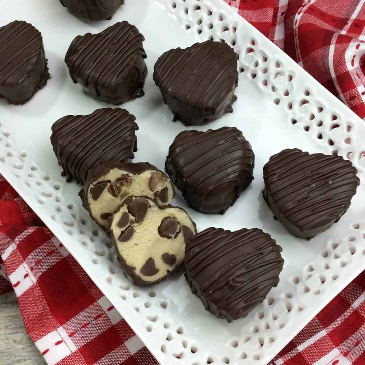 a platter of heart-shaped cookie dough truffles