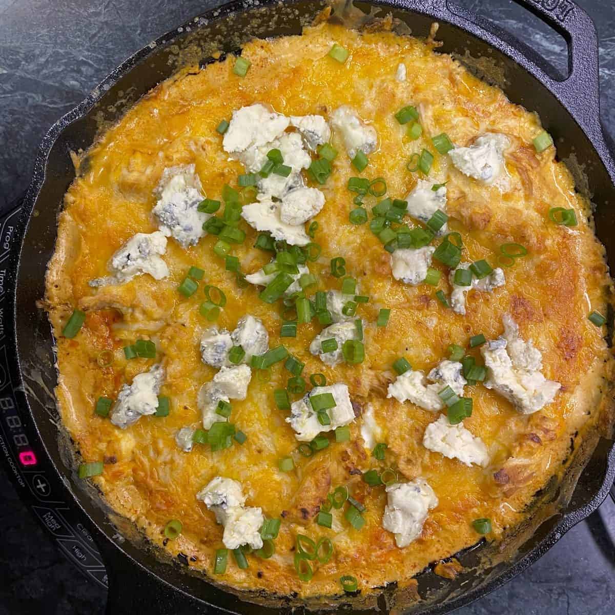 Buffalo chicken dip topped with blue cheese. recipe by foodology geek.