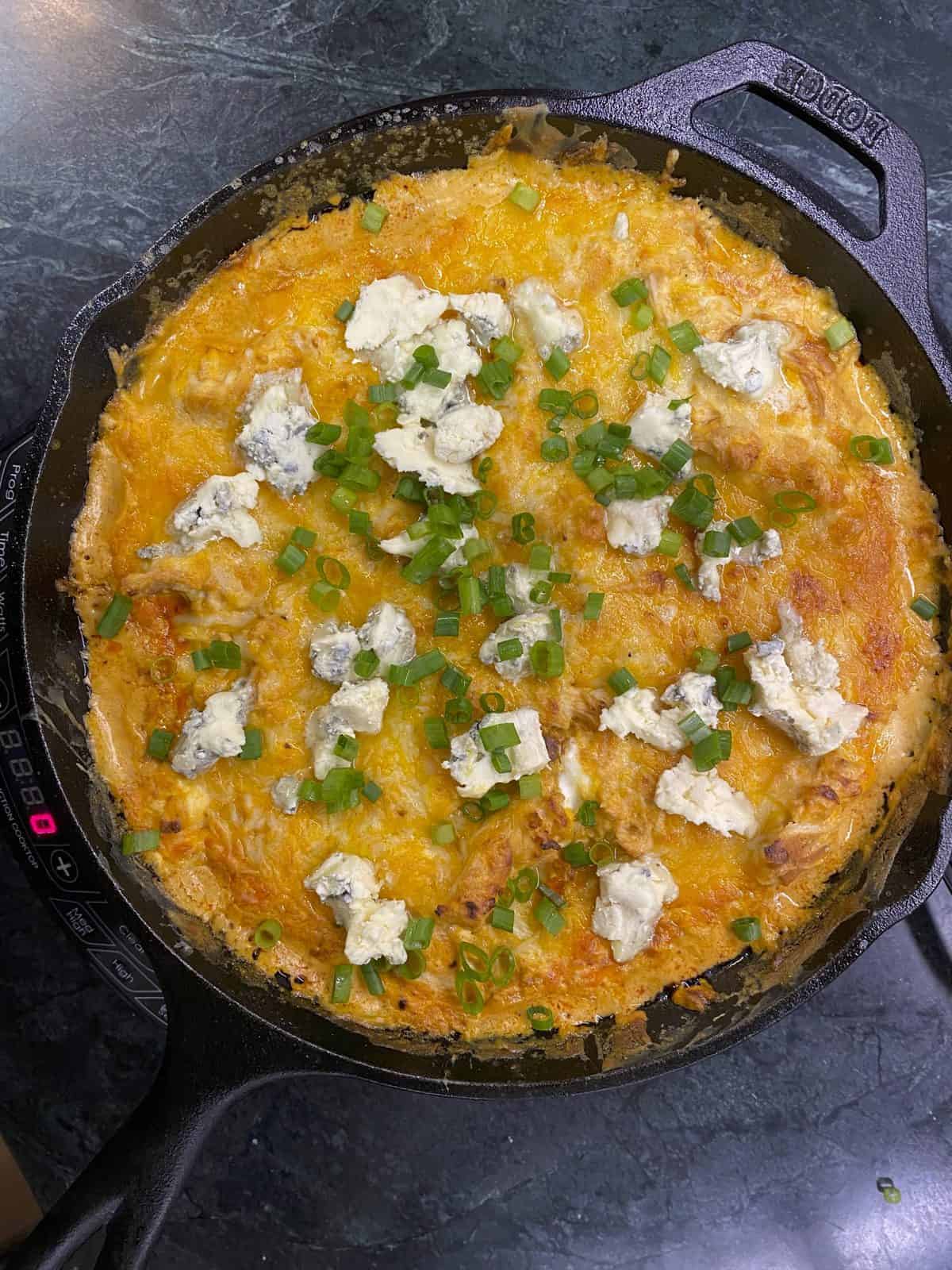 Buffalo chicken dip topped with blue cheese. recipe by foodology geek.
