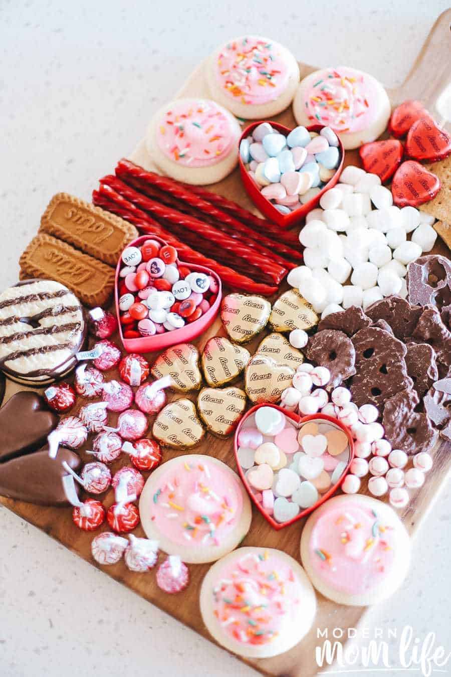 Dessert board filled with Valentines candies, cookies, and chocolates.