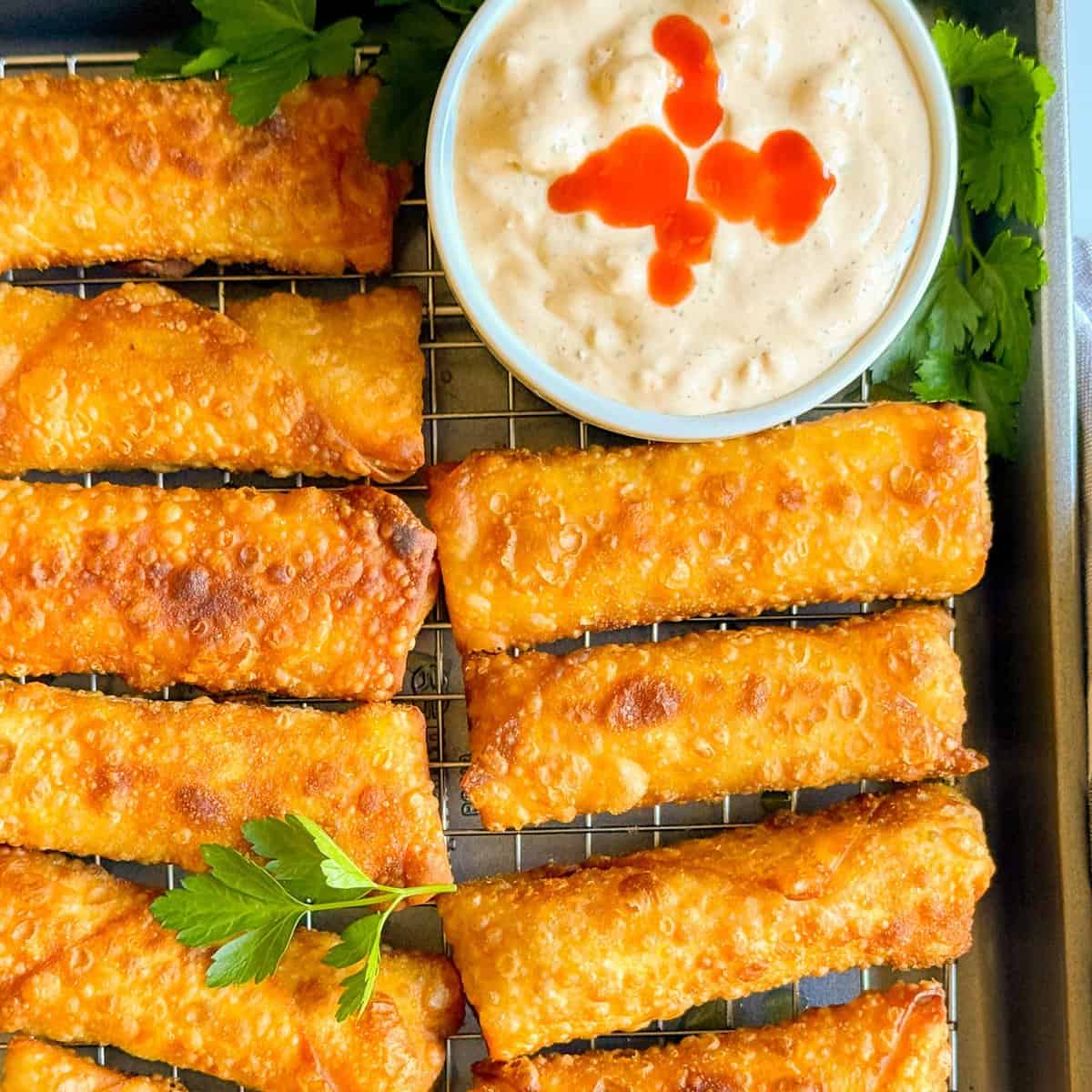 platter of buffalo chicken egg rolls served with buffalo ranch and buffalo wing sauce