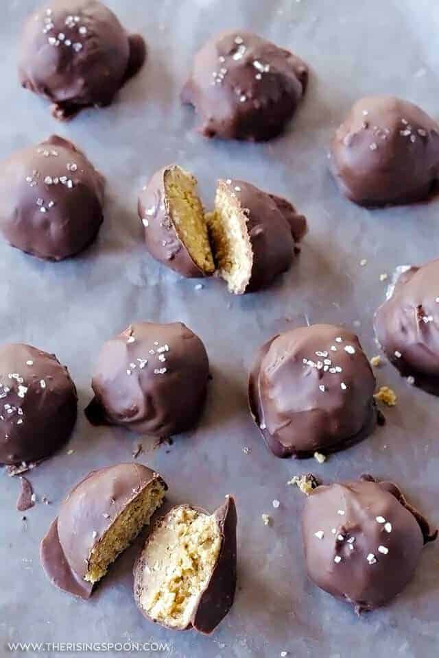 A baking tray full of vegan buckeye chocolate peanut butter balls.