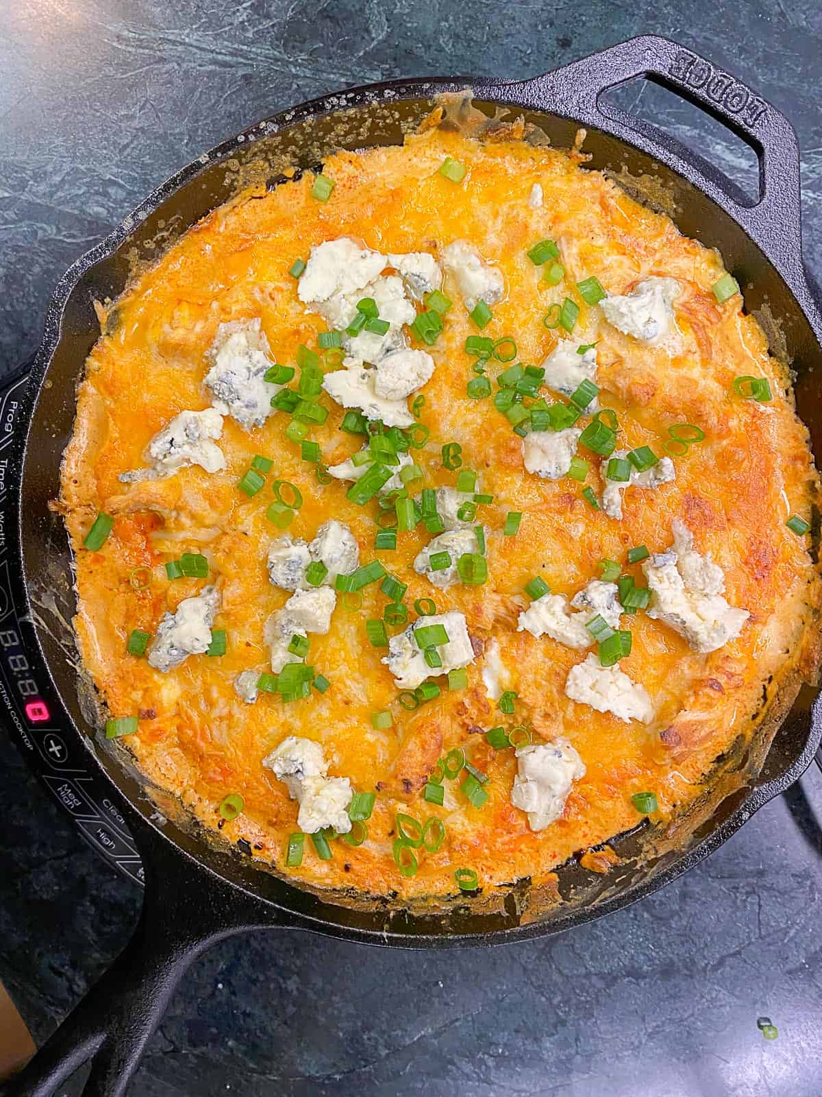 easy buffalo chicken dip in a cast iron skillet