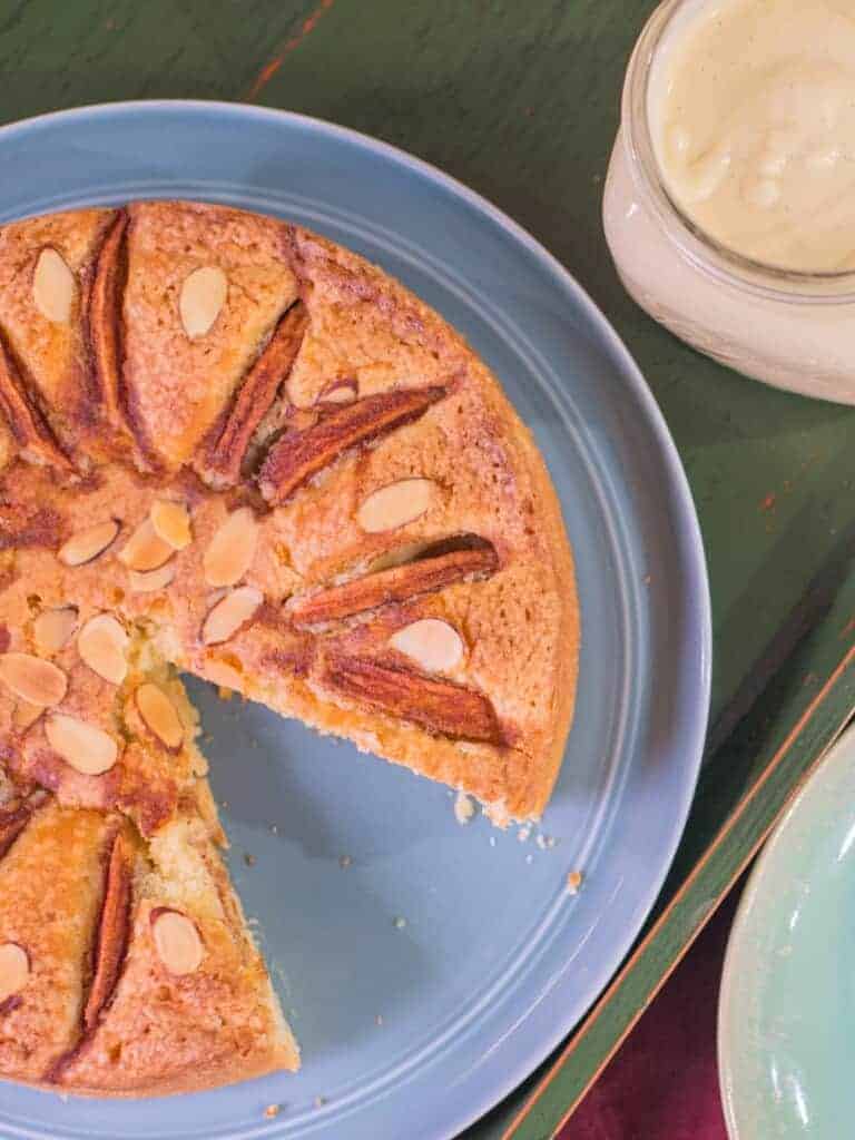 the best apple cake recipe with a slice cut out ans served with vanilla pastry cream