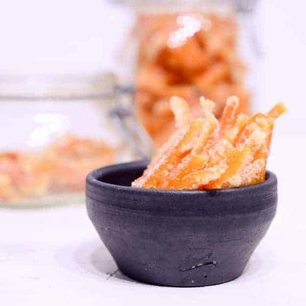 candied citrus peel in a black bowl