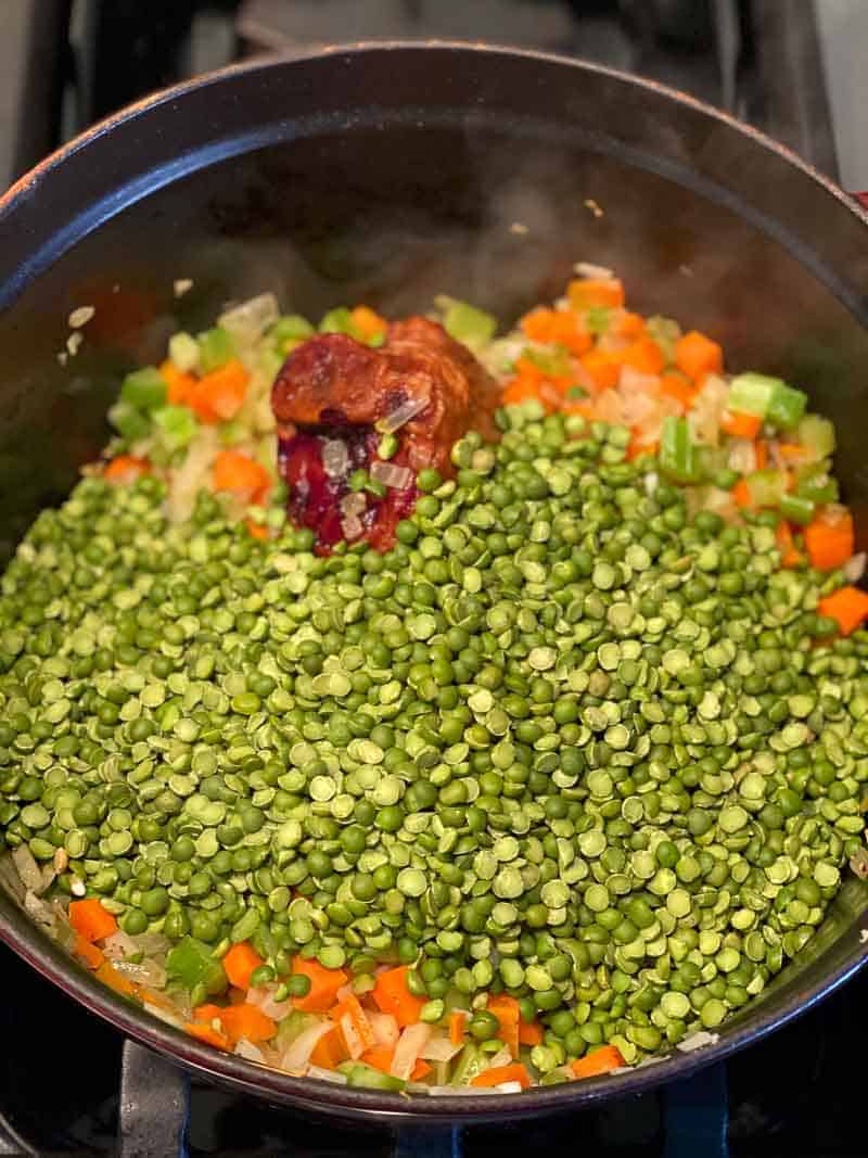 Ingredients for split pean soup in a dutch oven. recipe by foodology geek.