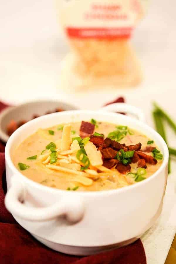 Loaded Baked Potato soup recipe with tillamook cheddar cheese in the background