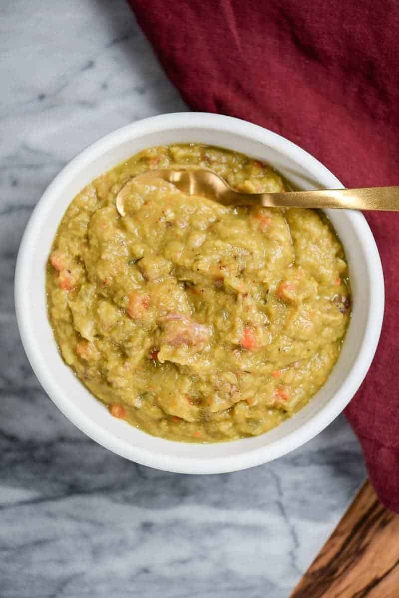 Bowl of split pea soup with a red napkin.