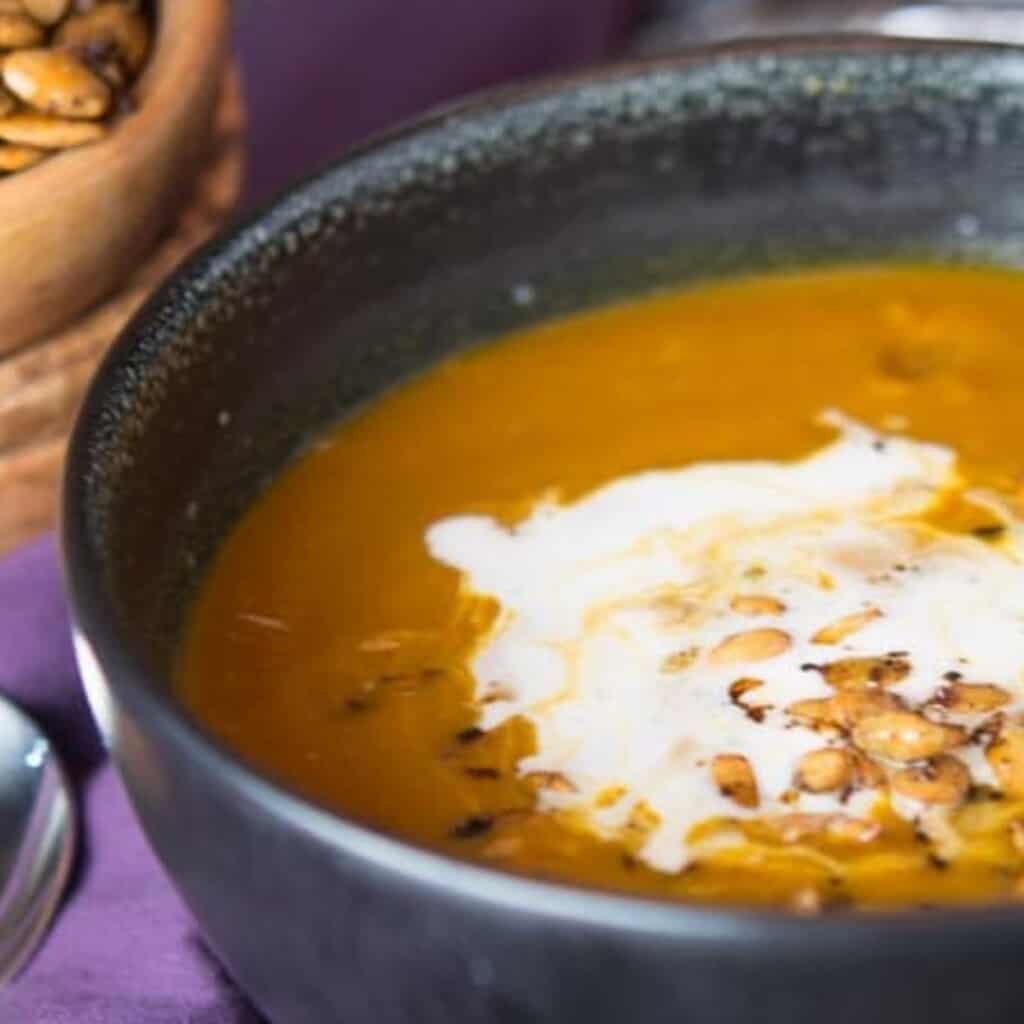 pumpki curry soup topped with creme fraiche and roasted pumpkin seeds. Easy and satisfying.
