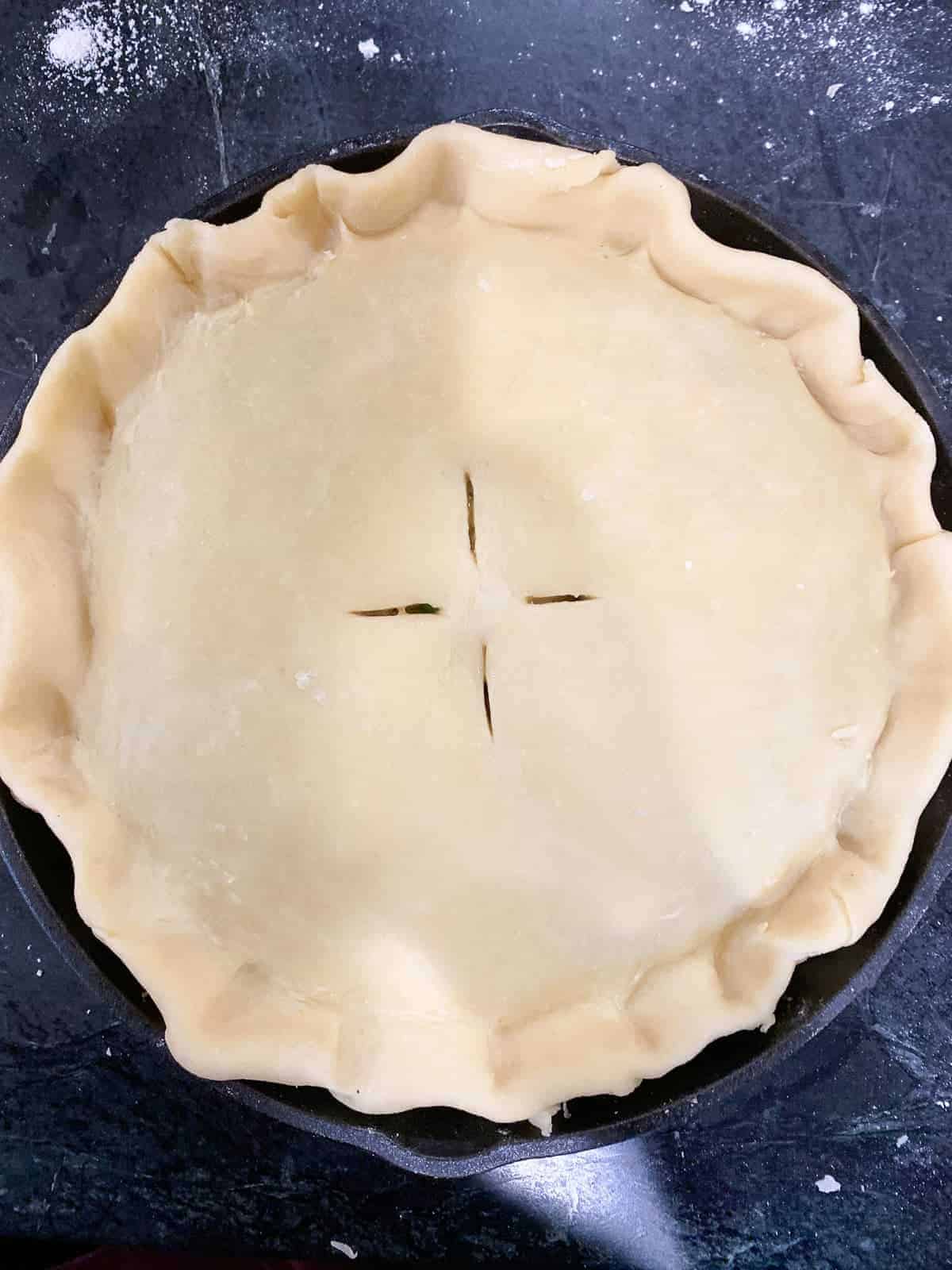 add the top pie crust and vent it with a knife