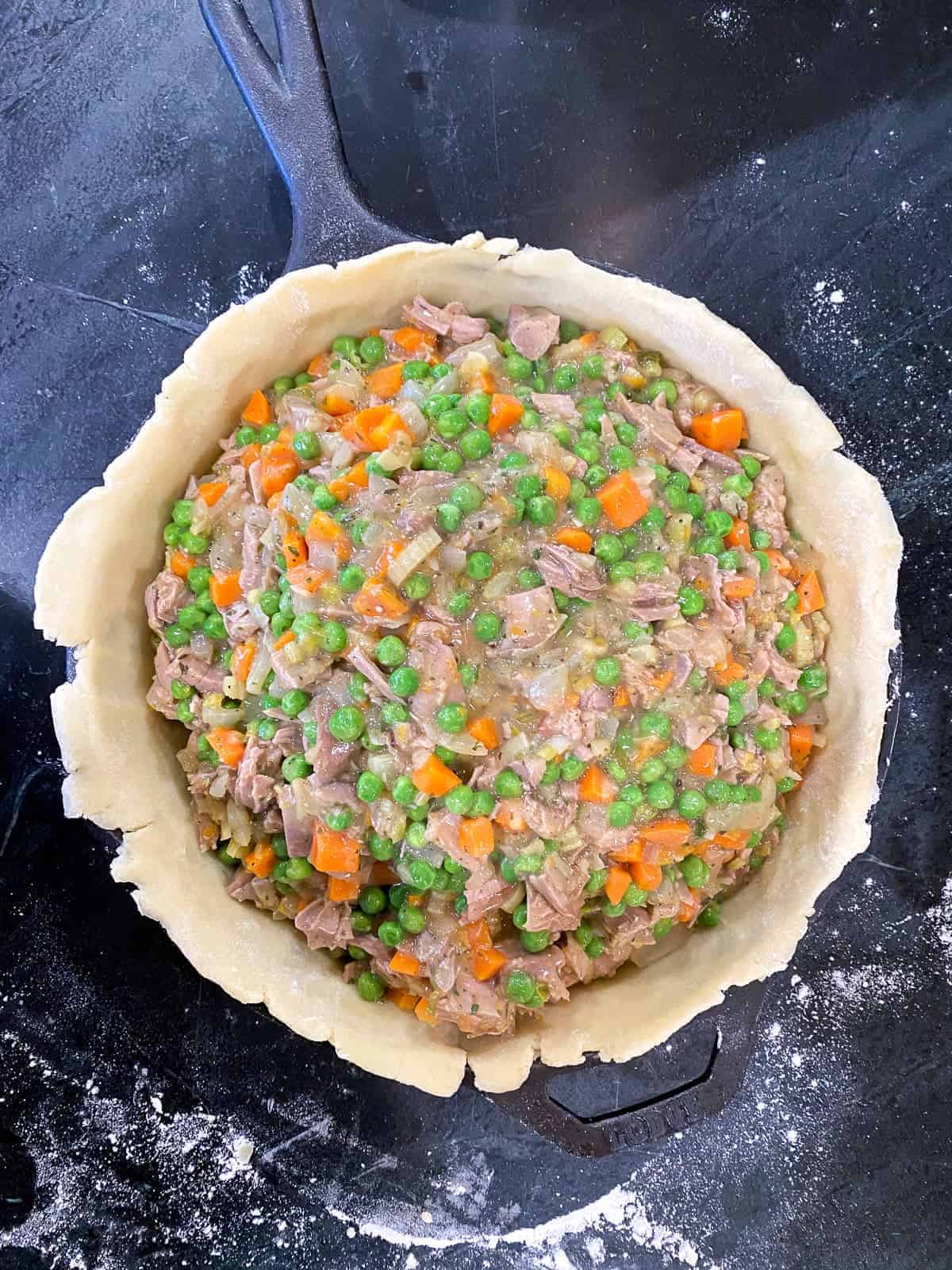 turkey pot pie filling in a cast iron skillet