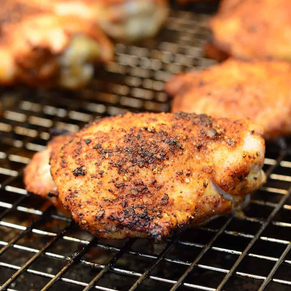 Cripsy baked chicken thighs on a wire rack. Extra crispy skin.